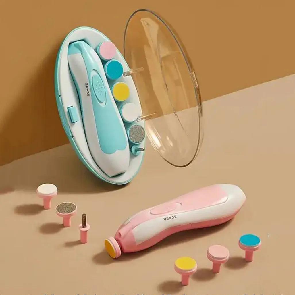 A pink and white electric foot file set with a matching oval case, shown with several interchangeable sanding and grinding attachments on a beige background.